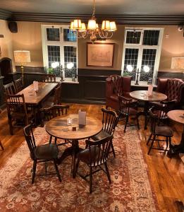 a restaurant with tables and chairs in a room at Red Lion in Bakewell