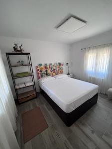 a bedroom with a large white bed in a room at Stone Garden, Casa en plena naturaleza in Uceda