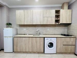 a kitchen with a sink and a washing machine at Guga House in Tbilisi City