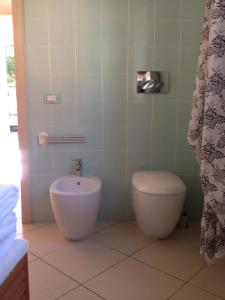 a bathroom with a toilet and a bidet at B&B La Pitagora in Comacchio