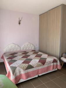 a bedroom with a bed with a checkered blanket at 2BR home with stunning sea and mountain views in Neo Chorio