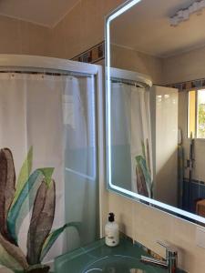 a bathroom sink with a mirror and a shower curtain at Playa del Ingles Estudio LOS MOLINOS 205 in Maspalomas
