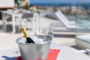a bucket with a wine bottle in it on a table at Deluxe Apartment in Costa Adeje in Adeje