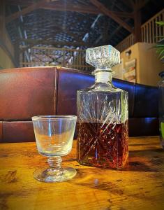 a bottle of whiskey and a glass on a table at Nicura Ranch Inn & Stables in Berea