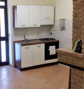 a kitchen with a stove and a sink in it at Casa Maria Russo in Casal Velino