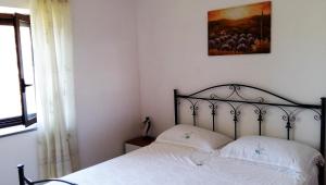 a bedroom with a bed and a painting on the wall at Casa Maria Russo in Casal Velino
