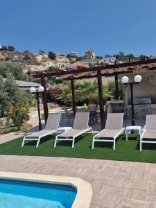 een patio met stoelen en een zwembad bij Magnolia CAPTAINS HOUSE with A POOL in Limassol