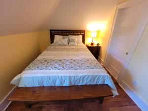 a bedroom with a bed with a wooden head board at The Hidden Inn in South Kortright