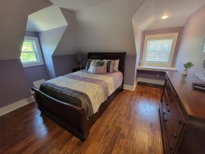 a bedroom with a bed and a dresser in it at The Hidden Inn in South Kortright