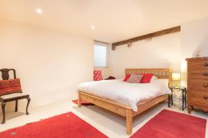 a bedroom with a bed and a dresser and a chair at The Lookout - A Great Adventure in Kingsbridge