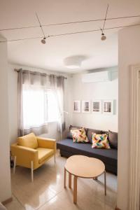 a living room with a couch and a table at Cozy house near to the city center of Granada in Granada