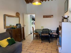 a living room with a couch and a table at La Maison et son adorable jardin clos in Porquerolles