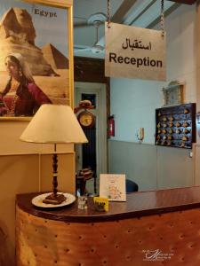 a table with a lamp on top of a counter at Triomphe Hostel in Alexandria