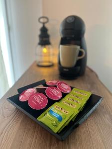 a packet of chocolate on a table next to a coffee maker at Appartement Evry in Évry-les-Châteaux