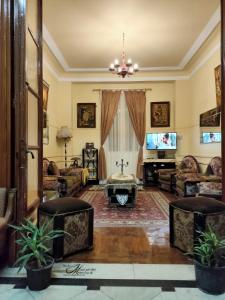 a living room with a couch and a tv at Triomphe Hostel in Alexandria