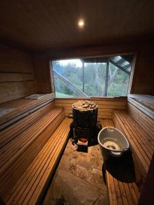 a inside of a sauna with a toilet and a window at Pucontours River Lodge in Pucón