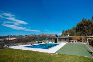 a house with a swimming pool and a mountain at Sorte do Castelo in Marco de Canaveses