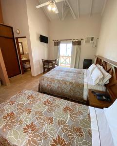 a hotel room with two beds and a table at Piedra de Agua in Federación +21 photos