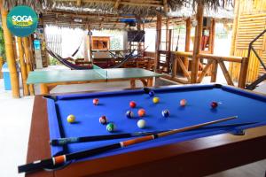 a pool table with balls on top of it at Soga Hostal in Santa Marianita