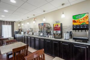 a fast food restaurant with a bar with tables and chairs at Super 8 by Wyndham Knoxville West/Farragut in Knoxville