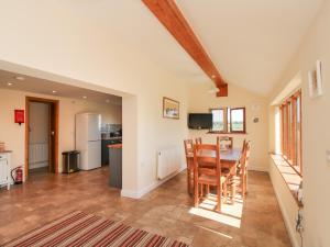 a kitchen and dining room with a table and chairs at Ellenhall Farm Cottage in Stafford