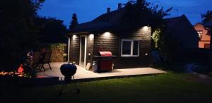 a house with a grill on a deck at night at Best Stay-Pärnu Villa in Pärnu