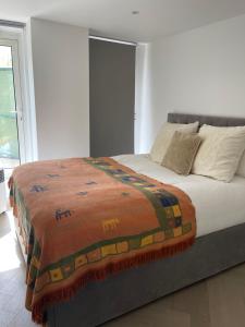 a bed with a blanket on it in a bedroom at Chelsea Pad by condokeeper in London