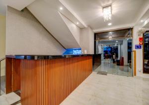 a lobby with a bar in a building at Hotel Sai Rain Tree in Guwahati