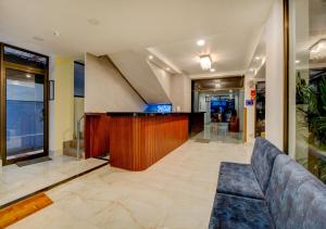 a lobby with a couch and a bar in a building at Hotel Sai Rain Tree in Guwahati