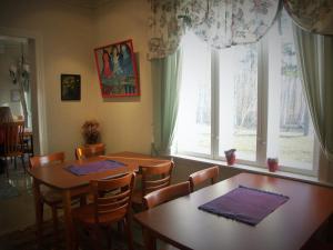 a dining room with two tables and a window at Villa Nurminata in Parikkala