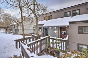 a house in the snow with a fence at Ian's Camelback House in Tannersville
