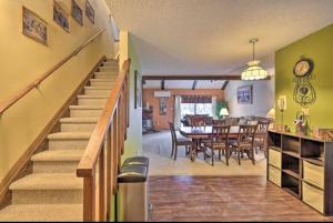 a living room with a staircase and a dining room at Ian's Camelback House in Tannersville