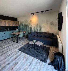 a living room with a blue couch and a table at Prima Apartmán Dolní Morava in Dolní Morava +11 photos