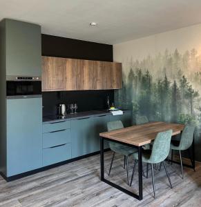 a kitchen with a table and chairs in a room at Prima Apartmán Dolní Morava in Dolní Morava