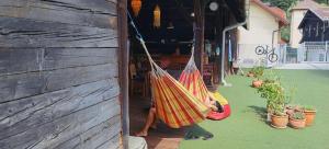 a person sitting in a hammock on a porch at BikeSki family hotel, b&b, apartaments, rooms in Mežica