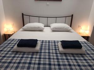 a bedroom with a bed with two pillows on it at Apartment Dipla in Athens