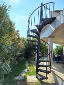 a spiral staircase on the side of a house at afa butrone sarrola in Afa