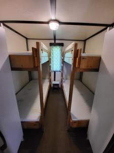 a room with three bunk beds and a light at Toska rekreační středisko in Prostřední Bečva