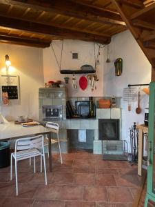 a kitchen with a table and a fireplace at Vidiecka chalupa 