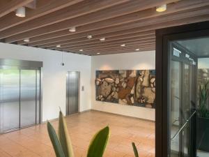 a lobby with a painting of a horse on the wall at Central Apartment with Panorama Rooftop & Free Parking in Aarhus