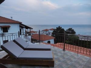 a balcony with a couch and a view of the ocean at Germanis House in Agios Ioannis Pelio
