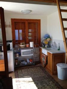 a kitchen with a refrigerator and a microwave at Manolates 360 views sea and mountains in Valeontádes