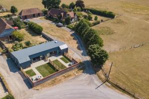 an overhead view of a house with a road and a building at Lacton Manor Barns by Bloom Stays in Ashford