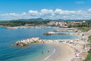 a group of people on a beach in the water at appartement en résidence vue mer , piscine… in Six-Fours-les-Plages +5 photos