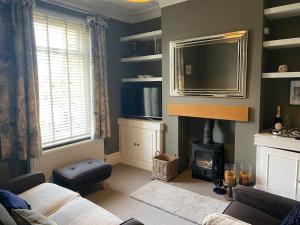 a living room with a fireplace and a mirror at Cheerful and spacious 3 bed home in Clitheroe in Clitheroe