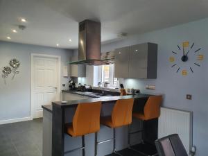 a kitchen with a counter and a clock on the wall at The White House in Elgin