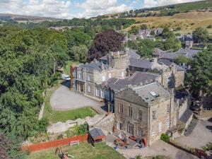 an aerial view of an old house with a yard at Cosy Cave Stanhope Castle in Bishop Auckland