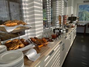 a breakfast buffet with bread and pastries on a counter at Panoramahotel Sonnhalde in Schwarzenberg