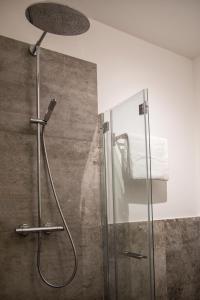 a shower with a glass door in a bathroom at Hotel San Francesco in Borgomanero
