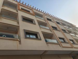 a building with windows on the side of it at Nador hay al Matar in Nador +6 photos